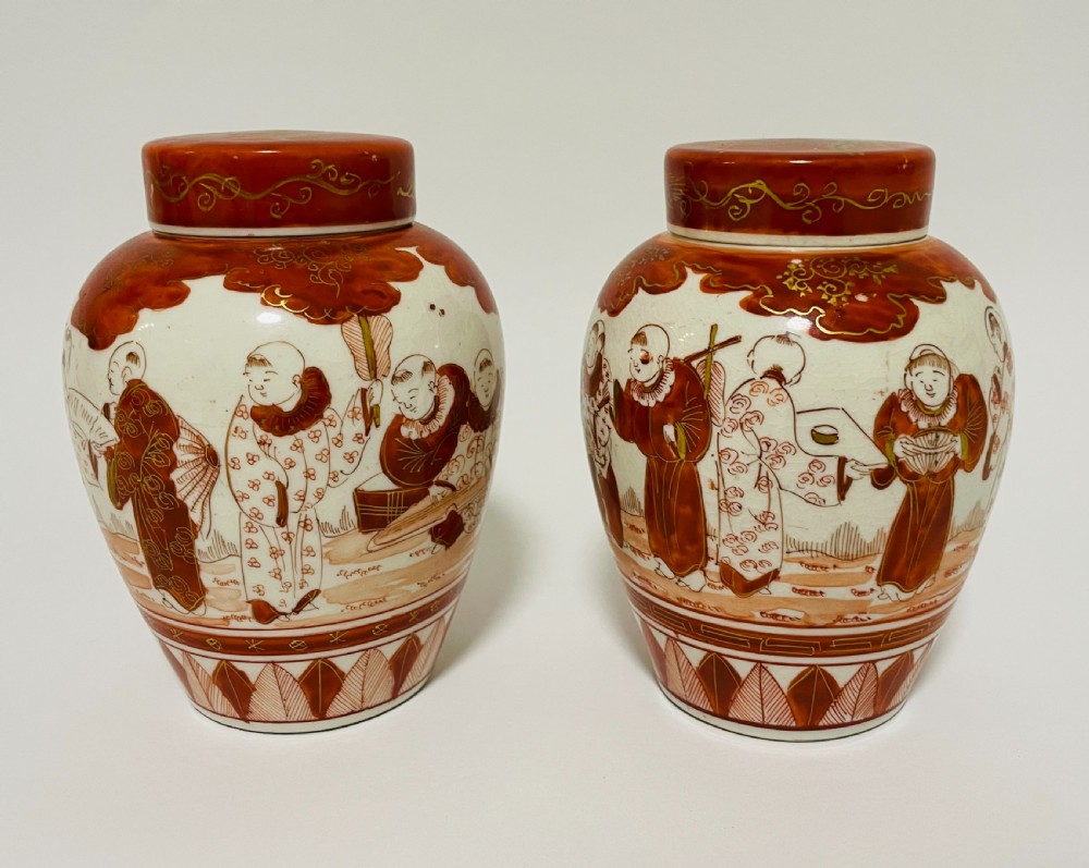 A pair of Japanese Kutani porcelain ginger jars decorated with iron-red hand-painted figures of children playing beneath decorative cloud and leaf borders. View III