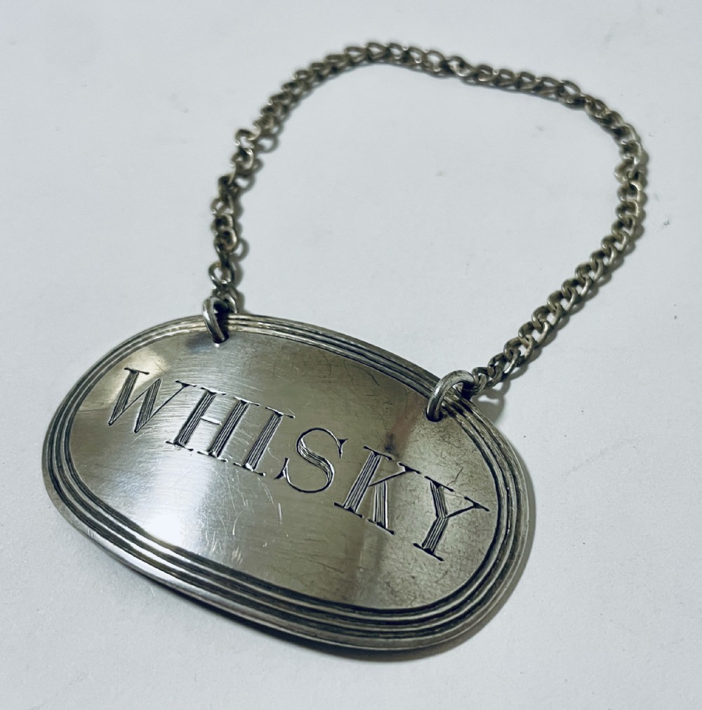 Antique Silver Whisky Label
