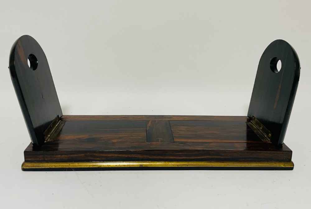 An antique Victorian coromandel wood expanding book slide featuring brass trim and decorative bone mounts pinned with studs. View II