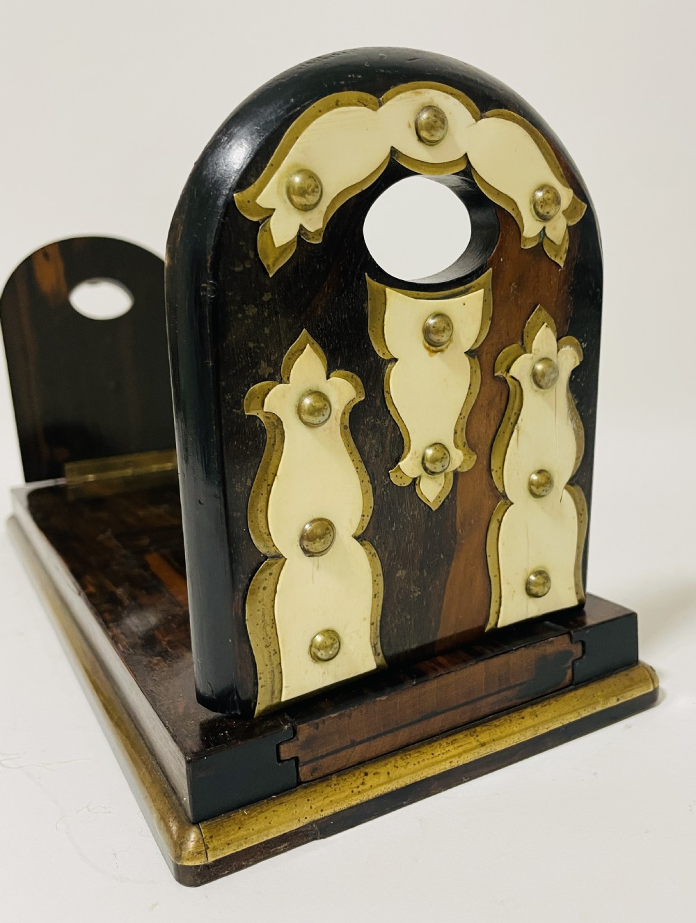 An antique Victorian coromandel wood expanding book slide featuring brass trim and decorative bone mounts pinned with studs. View V