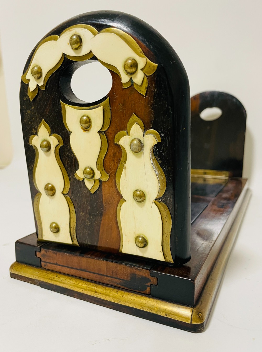 An antique Victorian coromandel wood expanding book slide featuring brass trim and decorative bone mounts pinned with studs. View VII