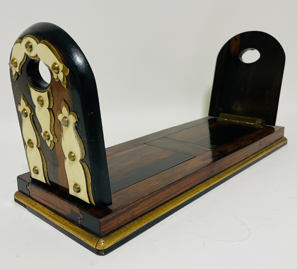 An antique Victorian coromandel wood expanding book slide featuring brass trim and decorative bone mounts pinned with studs. View VIII