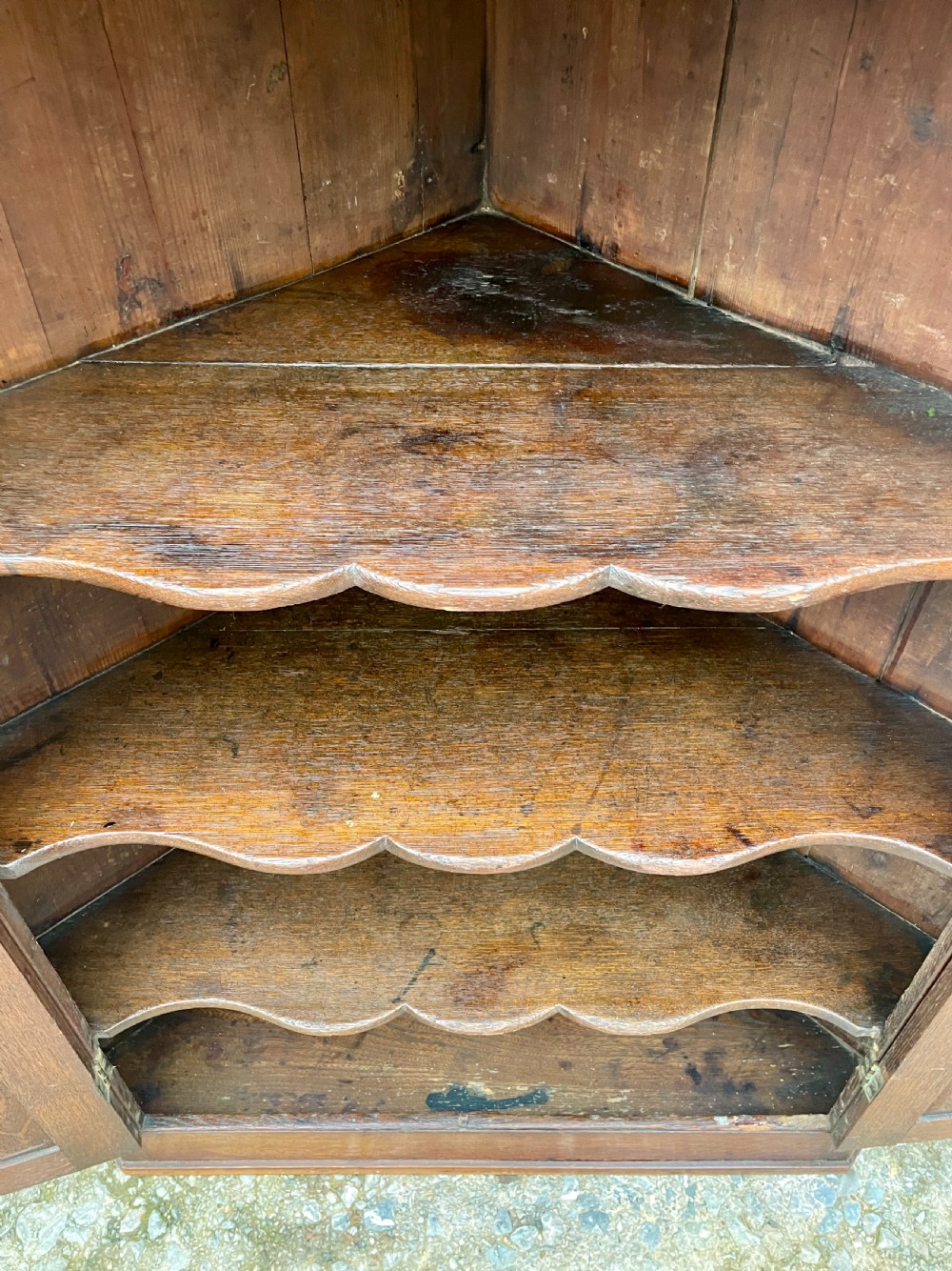 A floor-standing Georgian oak corner cupboard featuring double panelled doors and a moulded top cornice. View XIII