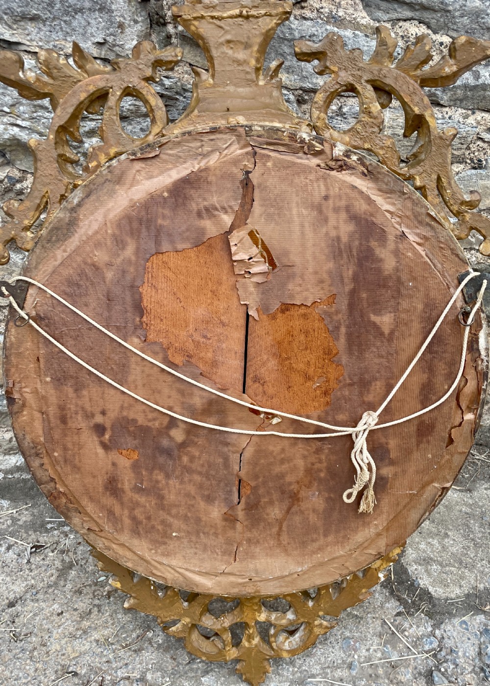 An ornate circular giltwood convex mirror featuring a carved eagle top cresting, acanthus leaf scrolling, ball mouldings, and an ebonised inner slip frame. View XI