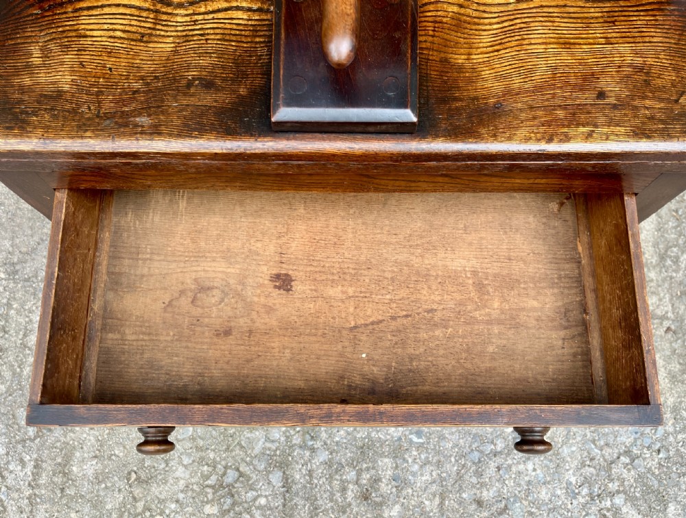 An antique oak and elm book press table featuring a central turned wooden screw mechanism above a single drawer with two round knobs. View XII