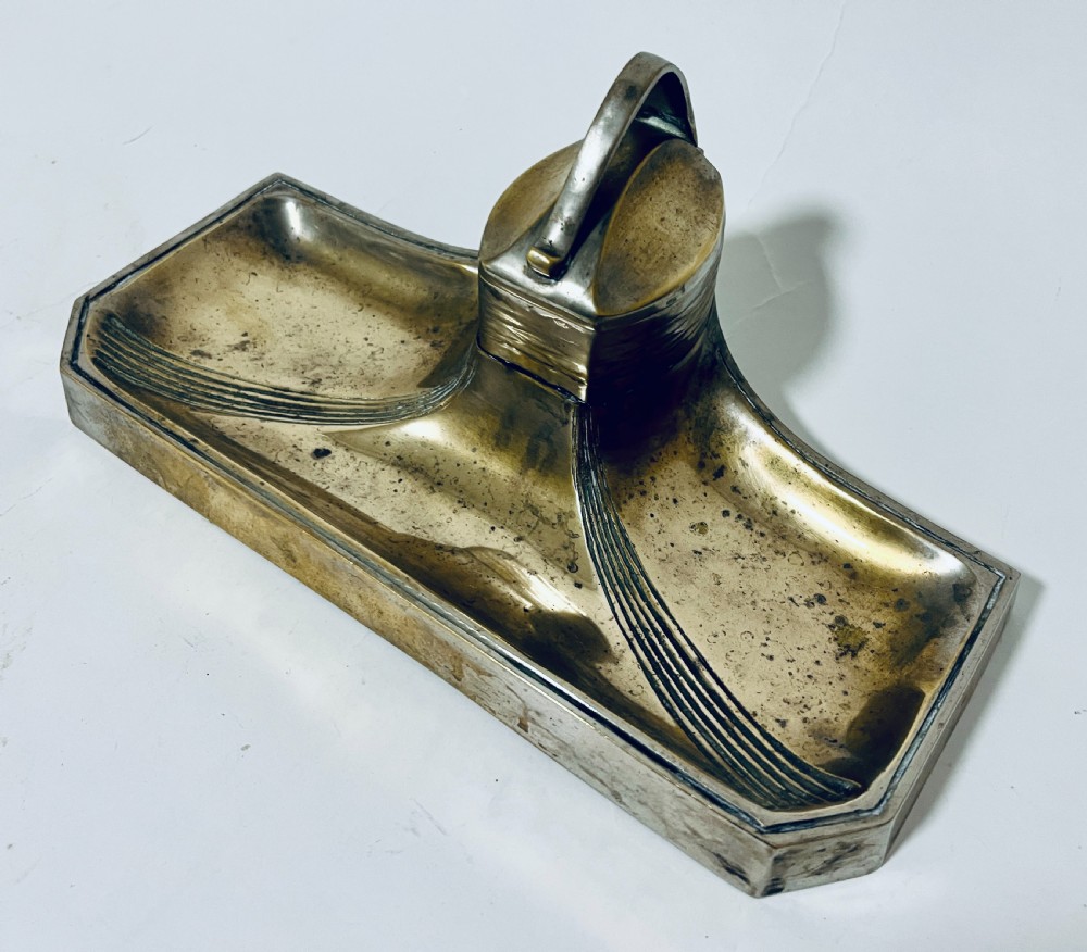 An antique Art Nouveau silver-plated desk stand featuring a central hinged inkwell flanked by two pen trays. View II