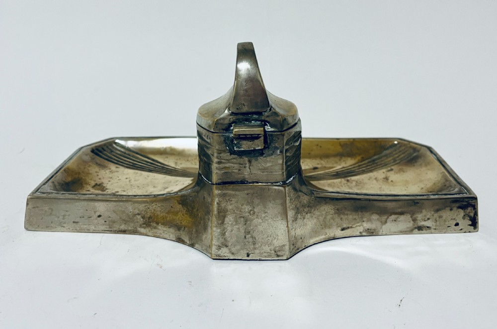An antique Art Nouveau silver-plated desk stand featuring a central hinged inkwell flanked by two pen trays. View III