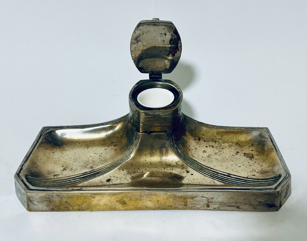 An antique Art Nouveau silver-plated desk stand featuring a central hinged inkwell flanked by two pen trays. View VI