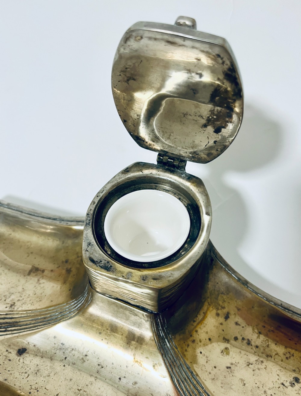 An antique Art Nouveau silver-plated desk stand featuring a central hinged inkwell flanked by two pen trays. View VII