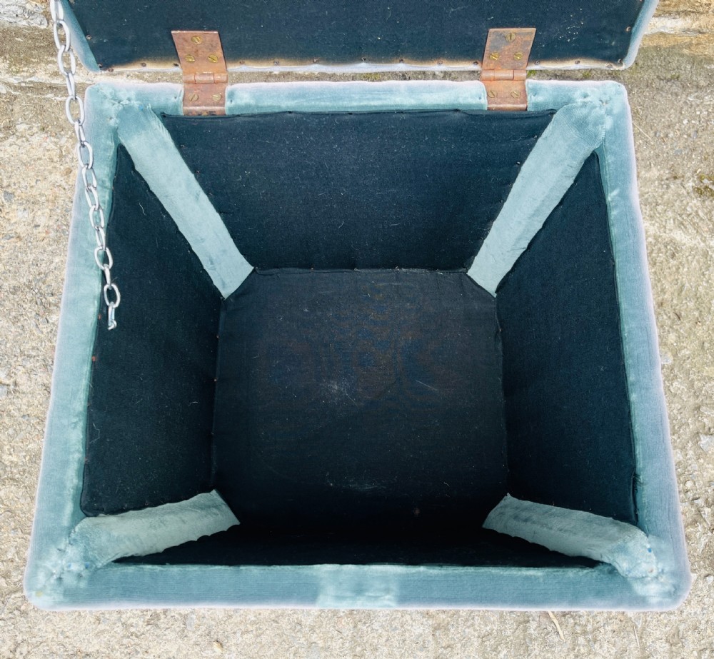 An upholstered grey velvet box ottoman featuring lower fringe trimming and dark mahogany carved lions paw feet. View V