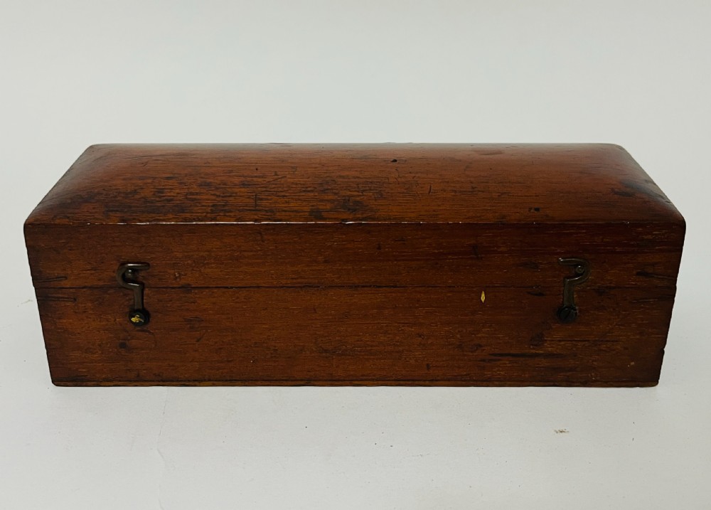 A Victorian brass drum microscope seated in its original fitted mahogany box with brass clasps. View VII