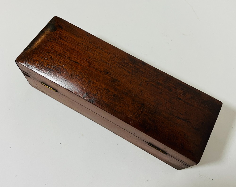 A Victorian brass drum microscope seated in its original fitted mahogany box with brass clasps. View X