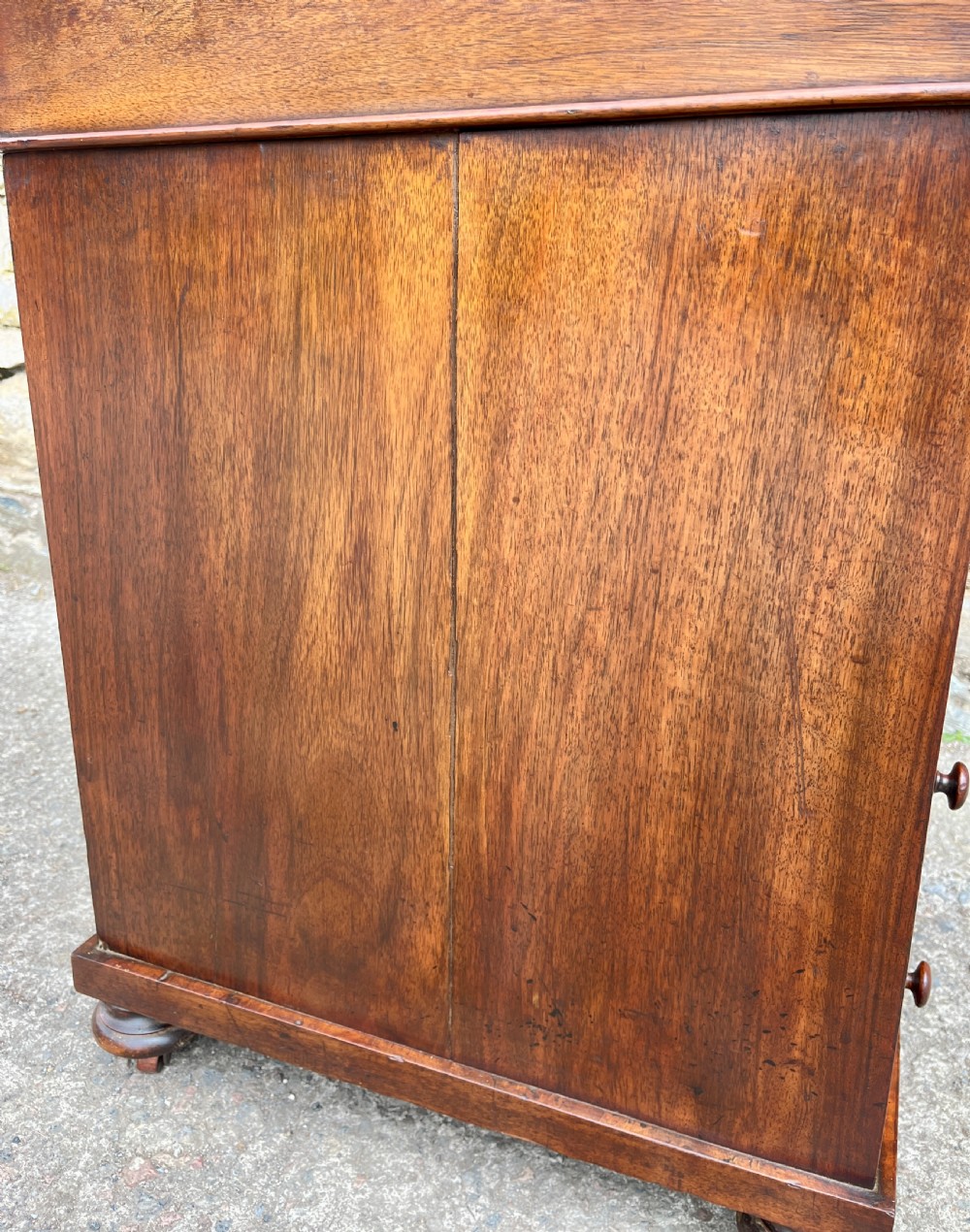 A Victorian burr walnut Davenport desk featuring a sloped writing top with a green leather insert and carved acanthus leaf front supports. View XVIII