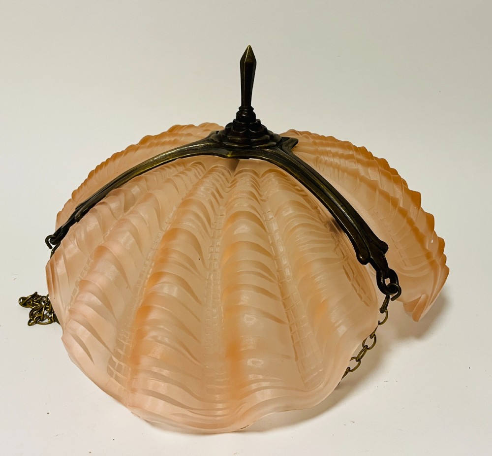 An Art Deco pink frosted glass clam shell ceiling pendant light suspended by three brass hanging chains. View VI