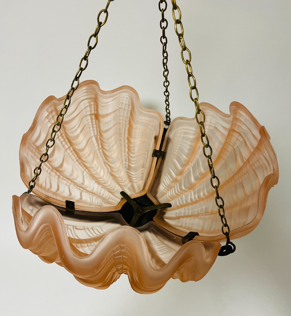 An Art Deco pink frosted glass clam shell ceiling pendant light suspended by three brass hanging chains. View VIII