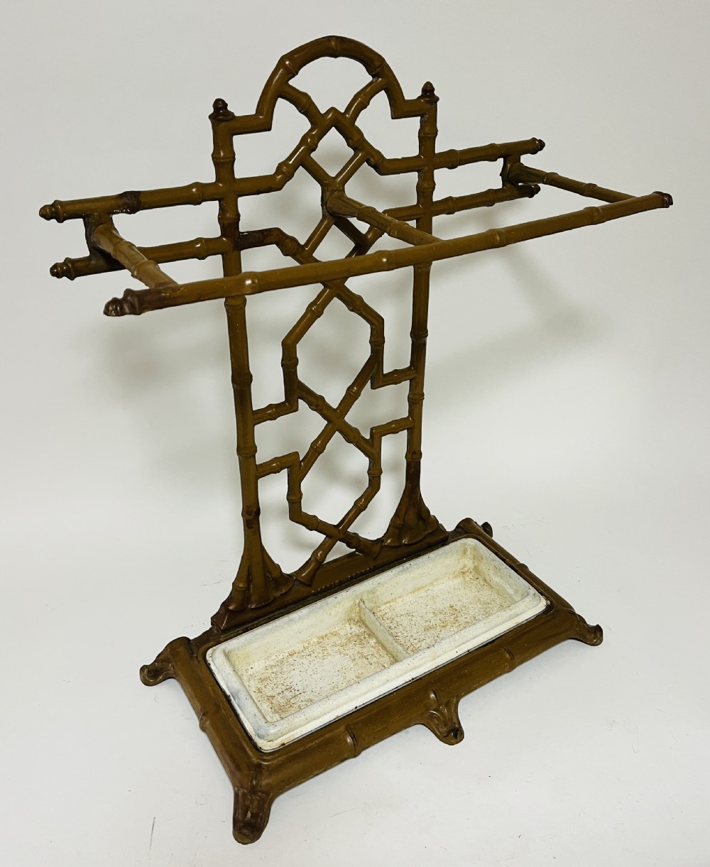 A Victorian cast iron faux bamboo umbrella stand in brown paint featuring geometric lattice backwork and a removable two-compartment drip tray. View XIV