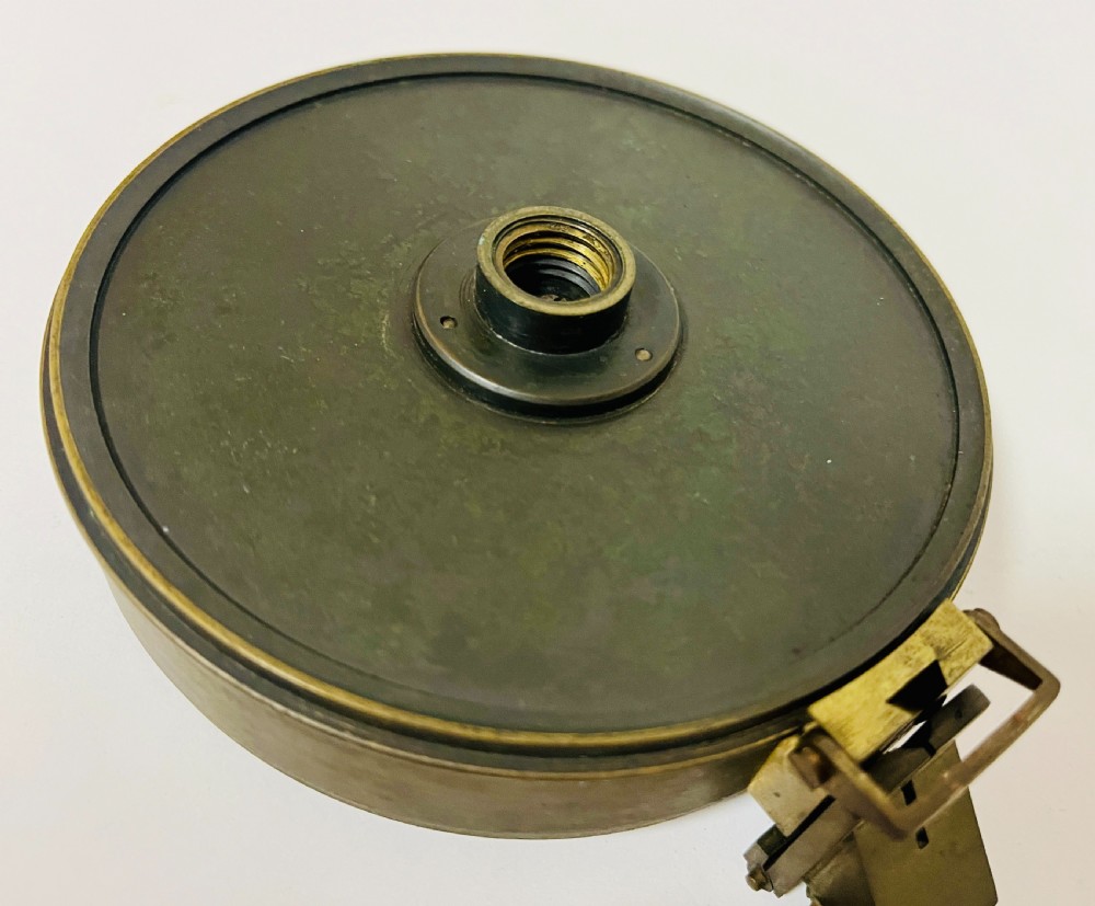 An antique brass surveying compass featuring folding sight vanes, a central needle, and a glass-covered dial. View VII