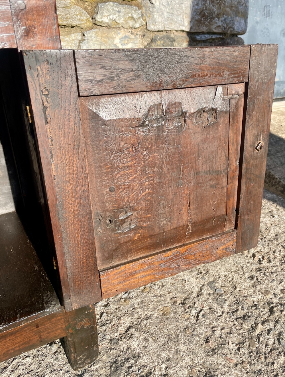 An antique dark oak Georgian dog kennel dresser featuring an open shelf rack above three drawers and two cupboard doors. View XIV
