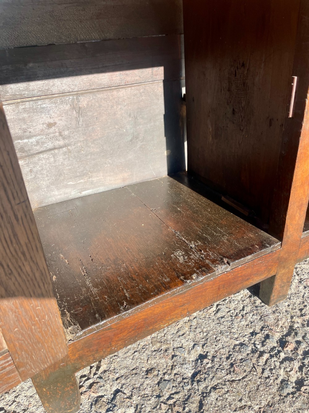 An antique dark oak Georgian dog kennel dresser featuring an open shelf rack above three drawers and two cupboard doors. View XV