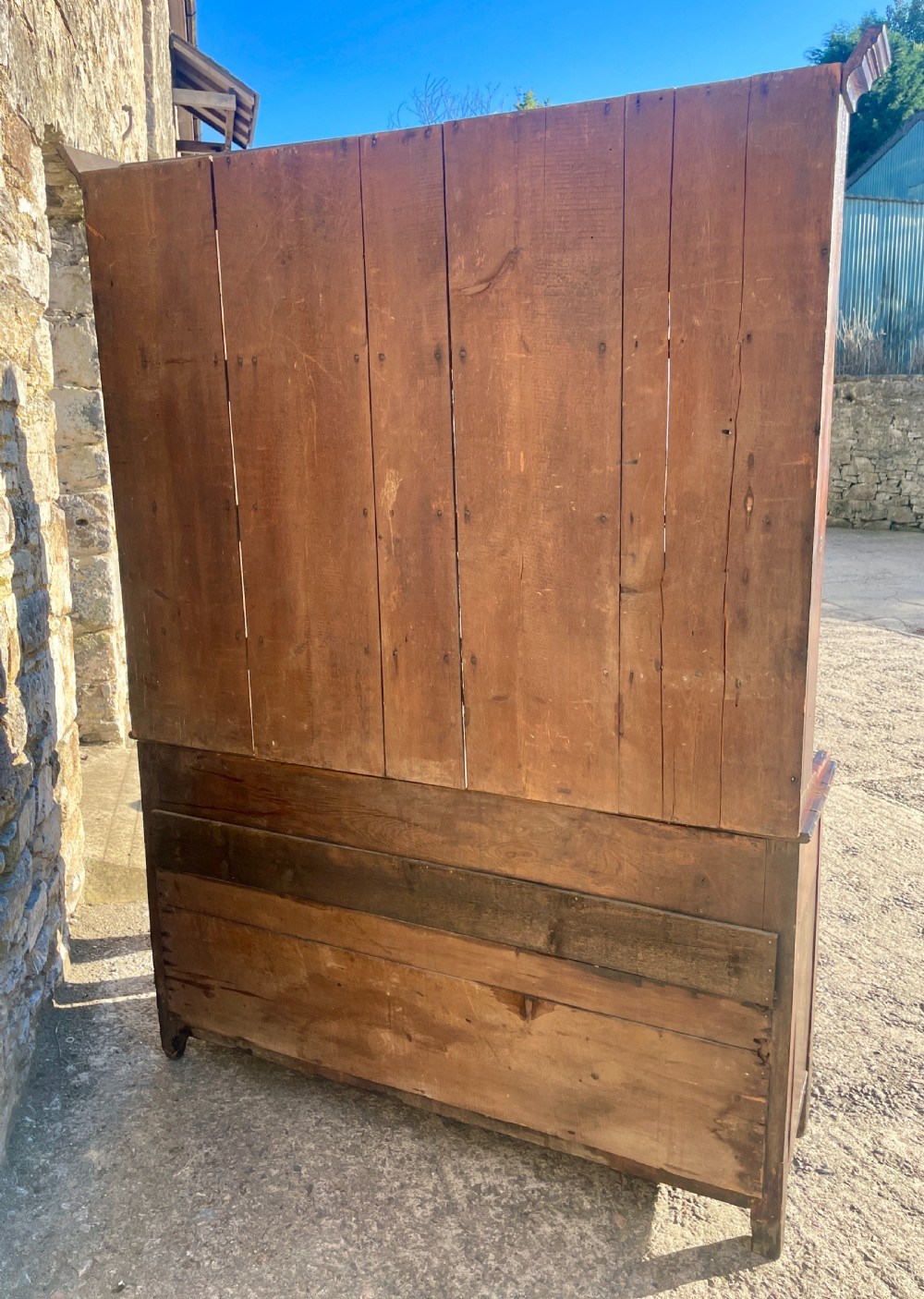 An antique dark oak Georgian dog kennel dresser featuring an open shelf rack above three drawers and two cupboard doors. View XVIII