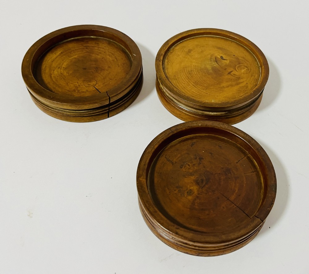 A set of three circular turned boxwood apothecary pill rounders with shallow central recesses and concentric moulded edges. View II