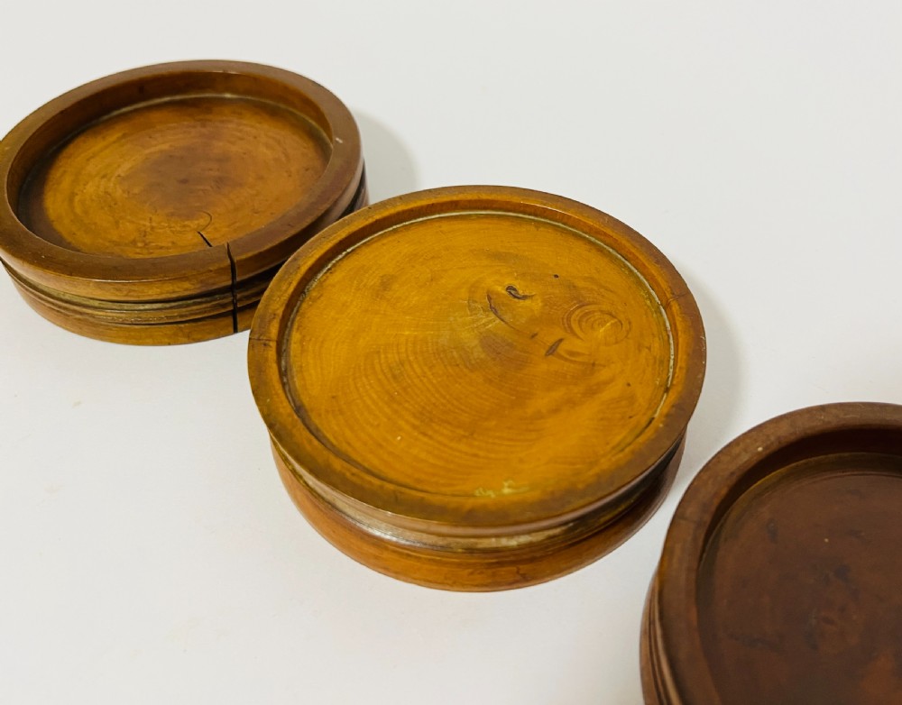 A set of three circular turned boxwood apothecary pill rounders with shallow central recesses and concentric moulded edges. View VIII