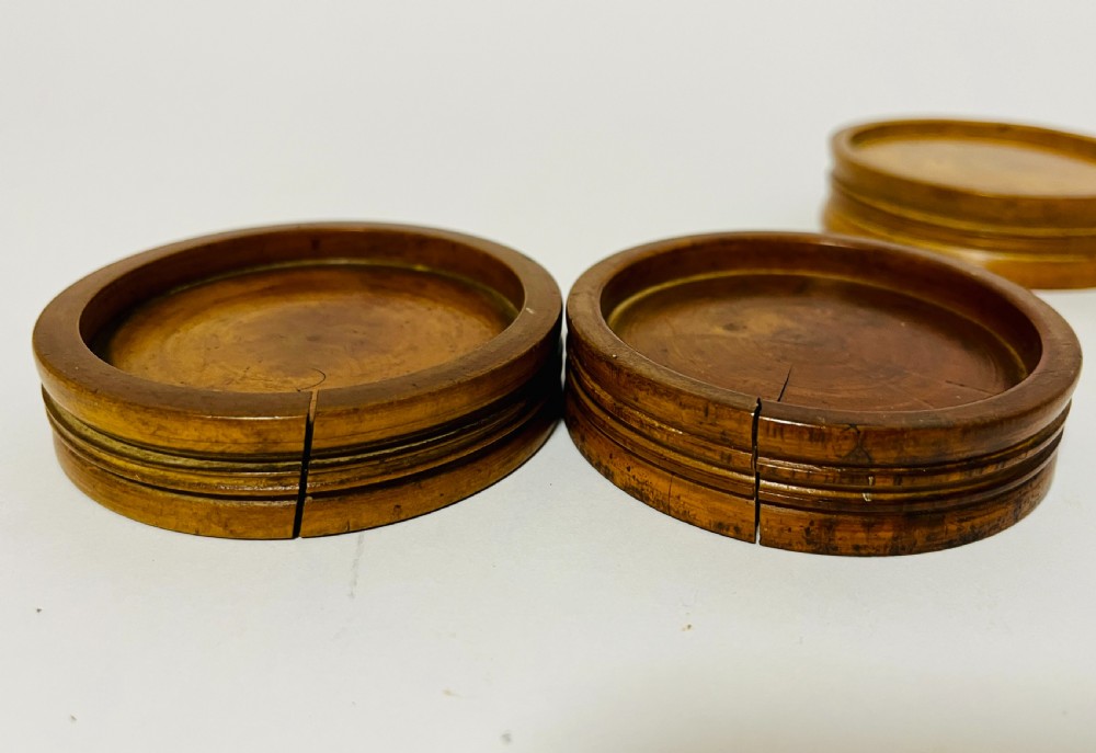 A set of three circular turned boxwood apothecary pill rounders with shallow central recesses and concentric moulded edges. View IX