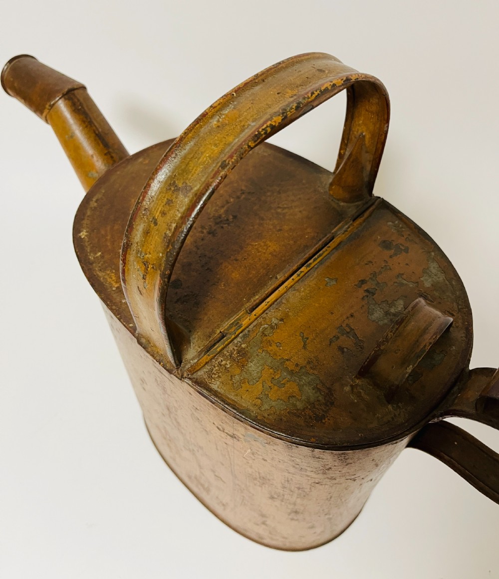 A Victorian painted tinplate hot water can featuring an overhead carrying handle, side loop handle, hinged lid, and angled spout. View VI