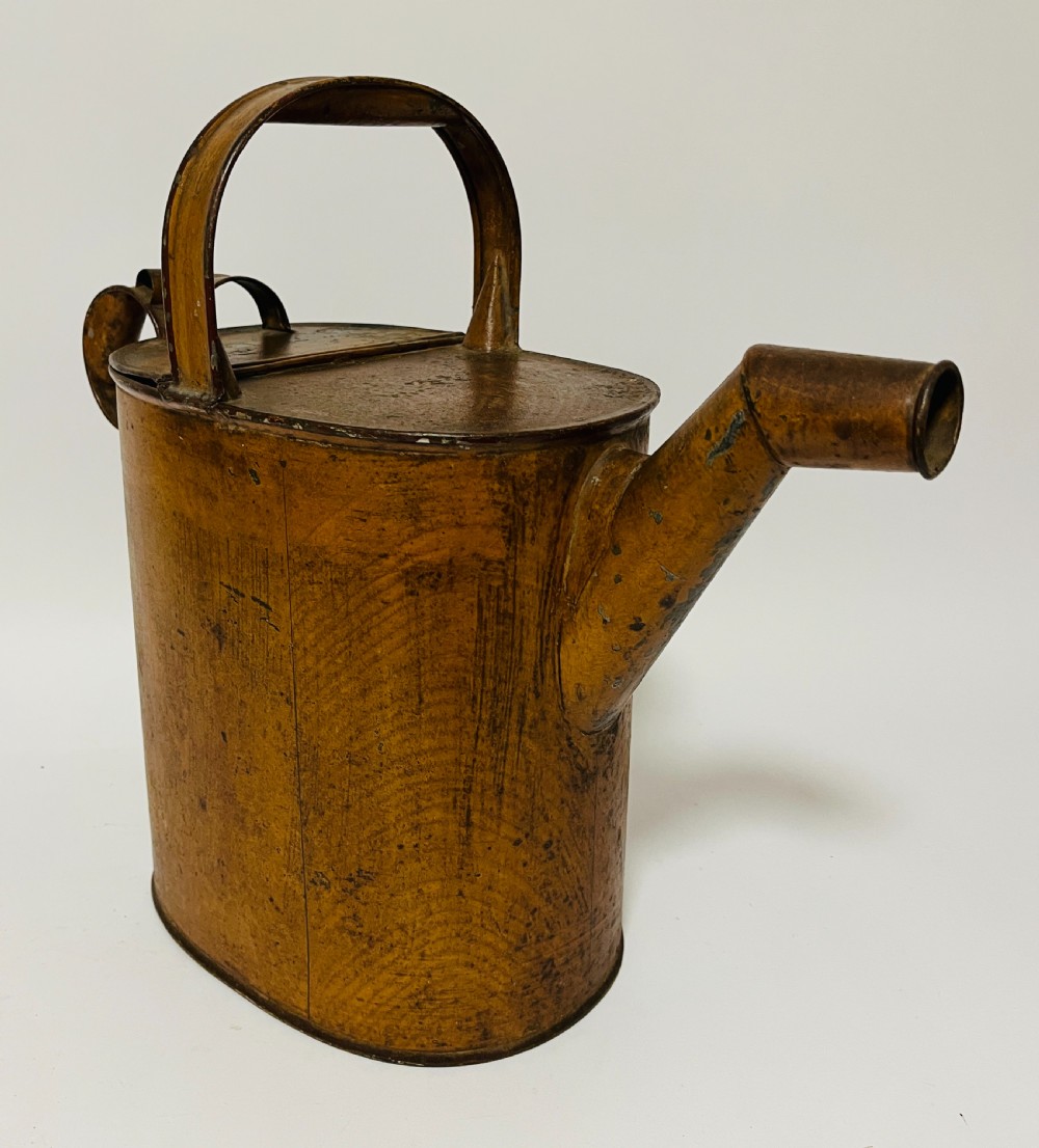 A Victorian painted tinplate hot water can featuring an overhead carrying handle, side loop handle, hinged lid, and angled spout. View VIII