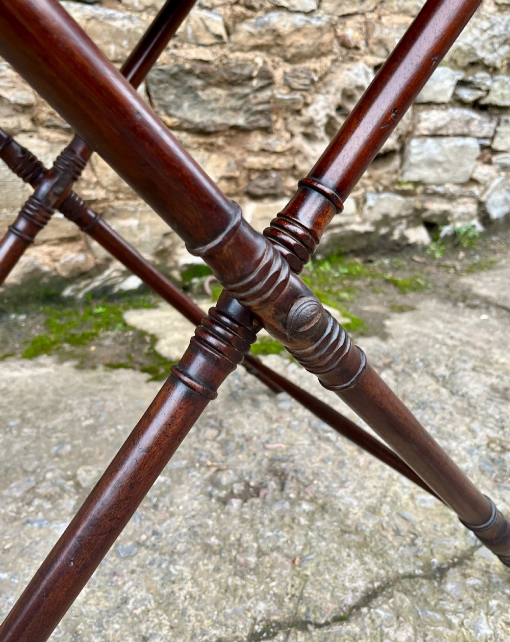A Georgian mahogany folding butlers tray table with a scalloped gallery border, heart-shaped cut-out handles, and a turned X-frame stand. View VII