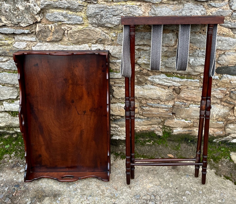A Georgian mahogany folding butlers tray table with a scalloped gallery border, heart-shaped cut-out handles, and a turned X-frame stand. View XV