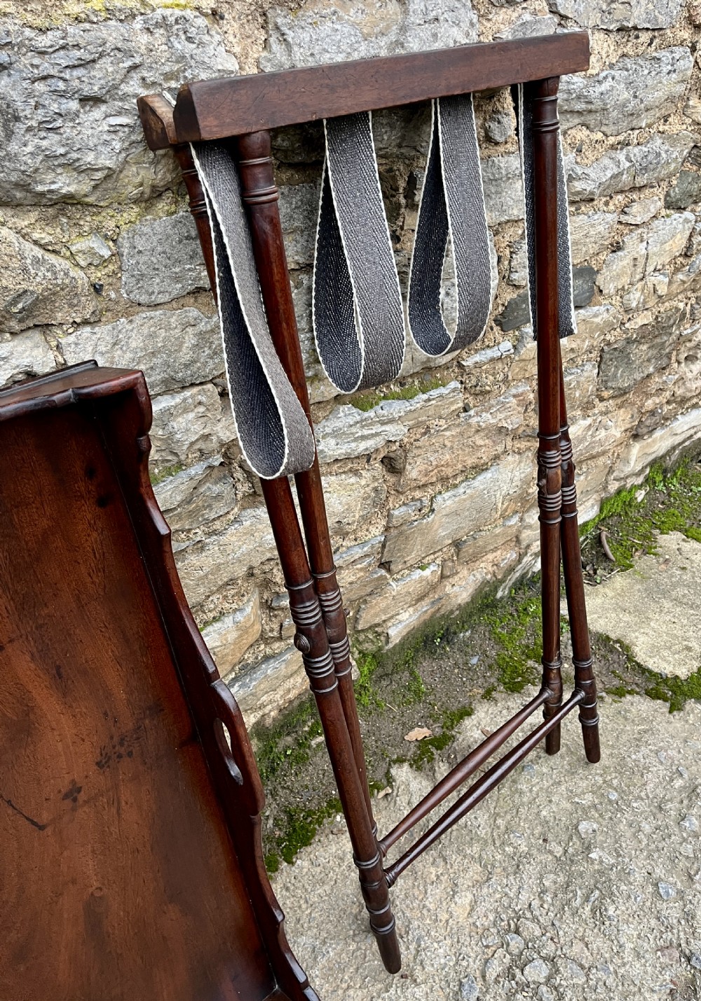 A Georgian mahogany folding butlers tray table with a scalloped gallery border, heart-shaped cut-out handles, and a turned X-frame stand. View XIX