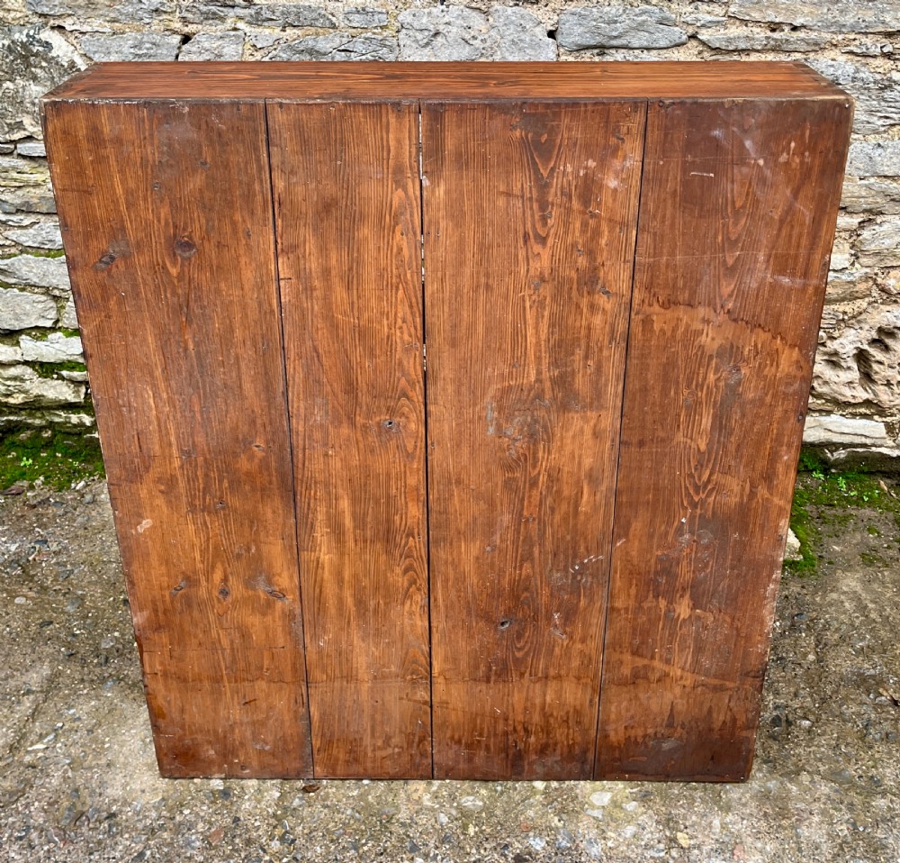 A large square wooden storage unit featuring a six-by-six grid of thirty-six rectangular cubbies made of dark stained pine. View IX