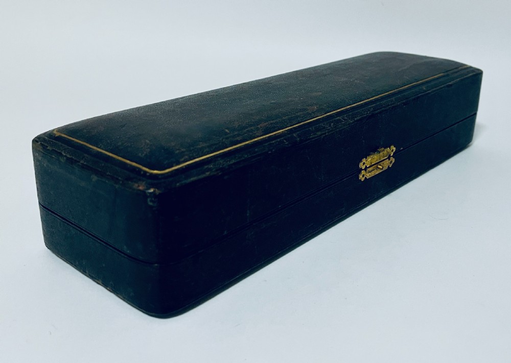 A three-piece Victorian silver condiment set with matching spoons displayed inside a fitted blue satin-lined dark presentation case. View XIII