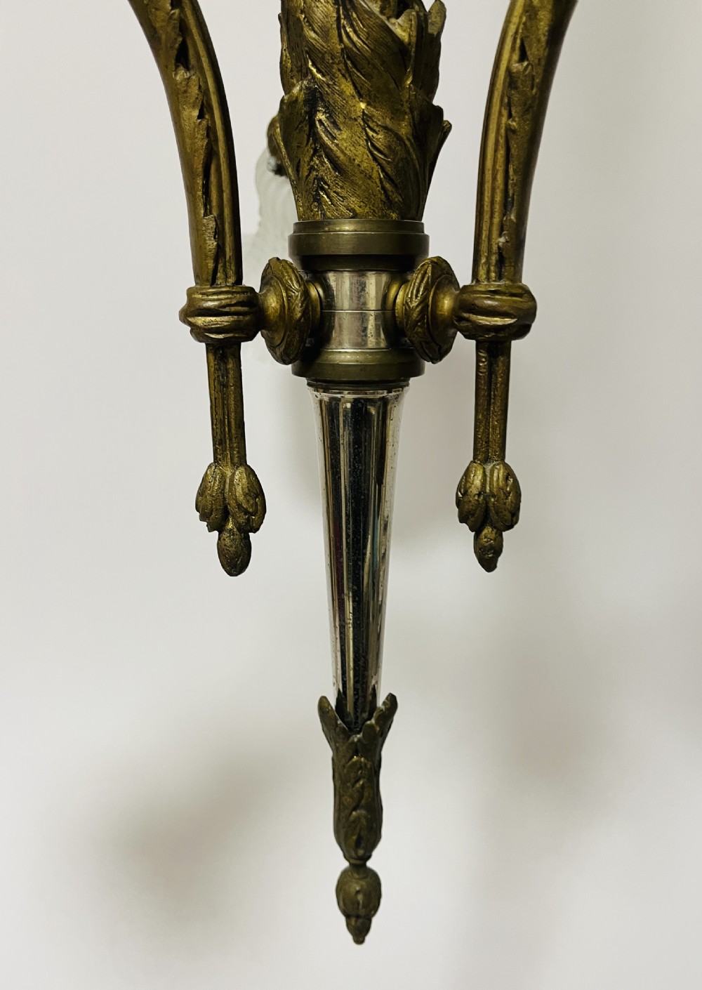 A French Empire style bronze chandelier featuring three ornate scrolling arms with frosted glass ruffled shades and hanging chain details. View VII