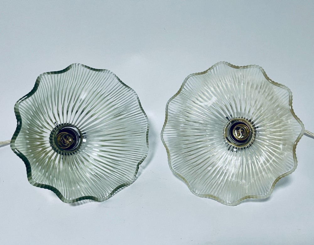 A pair of clear ribbed prismatic glass pendant light shades fitted with brass collars and light braided flex cords. View VI