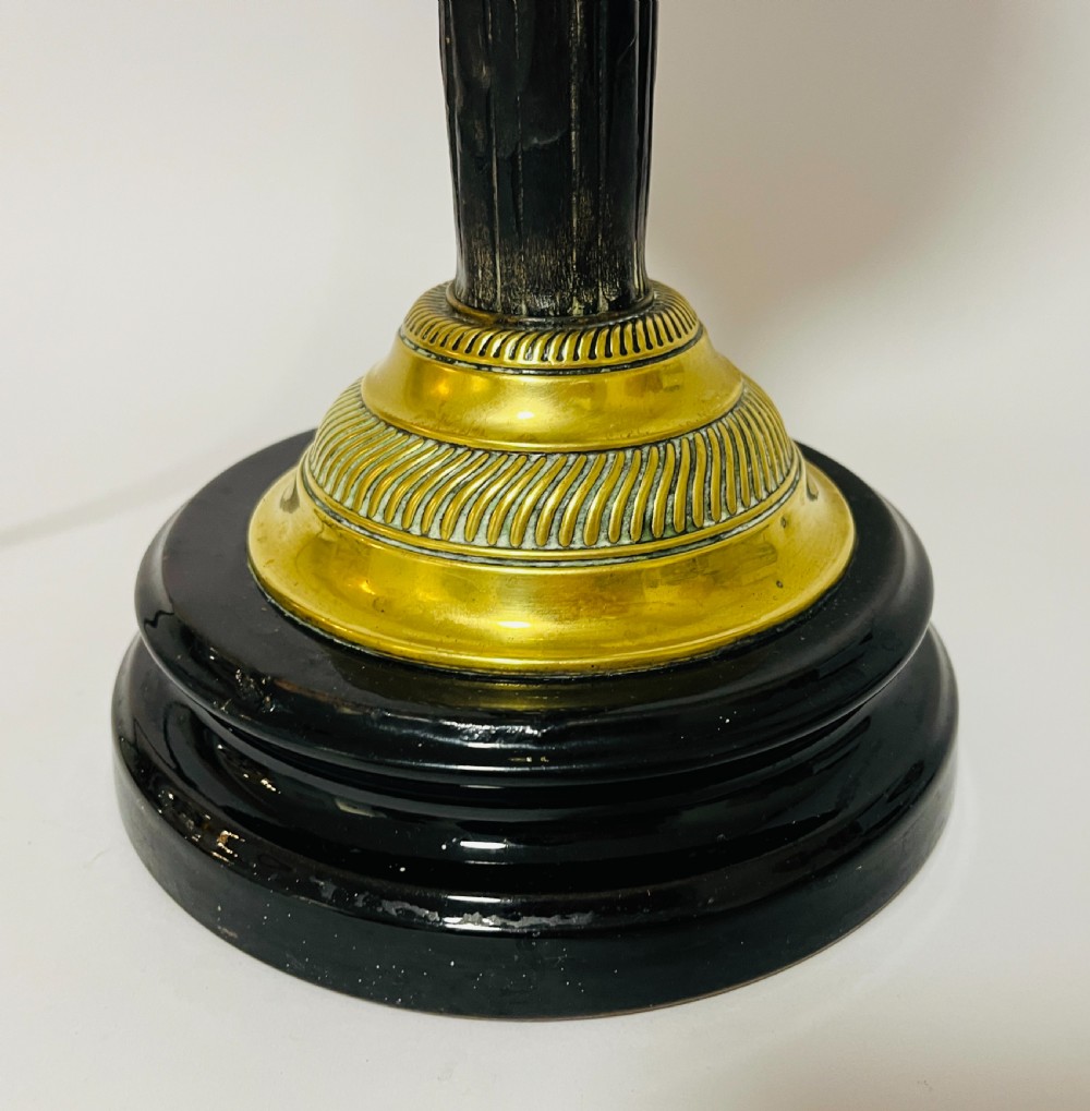 An antique Victorian embossed brass oil lamp converted into an electric table lamp with a reeded column and black circular base. View IV