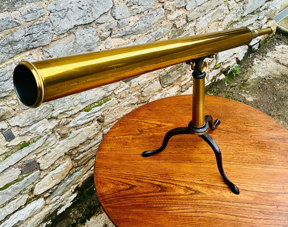 A Victorian brass library telescope supported by a black cast iron tripod desktop base. View XIII