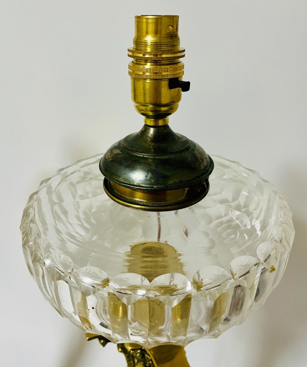 A pair of brass Corinthian column table lamps featuring stepped square plinths, fluted columns, acanthus capitals, and cut glass reservoirs. View V