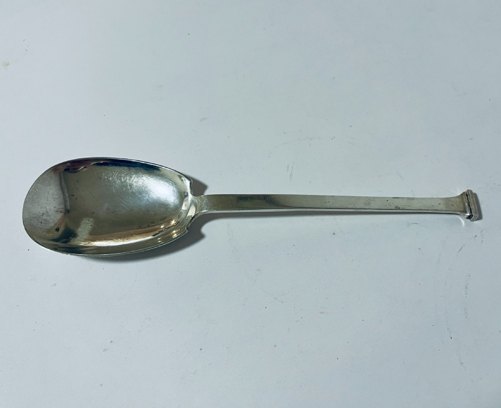 A silver seal top spoon featuring a wide oval bowl, straight stem, and a flat seal terminal.