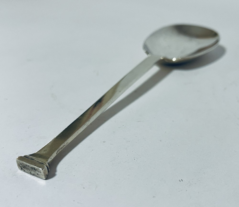 A silver seal top spoon featuring a wide oval bowl, straight stem, and a flat seal terminal. View IV