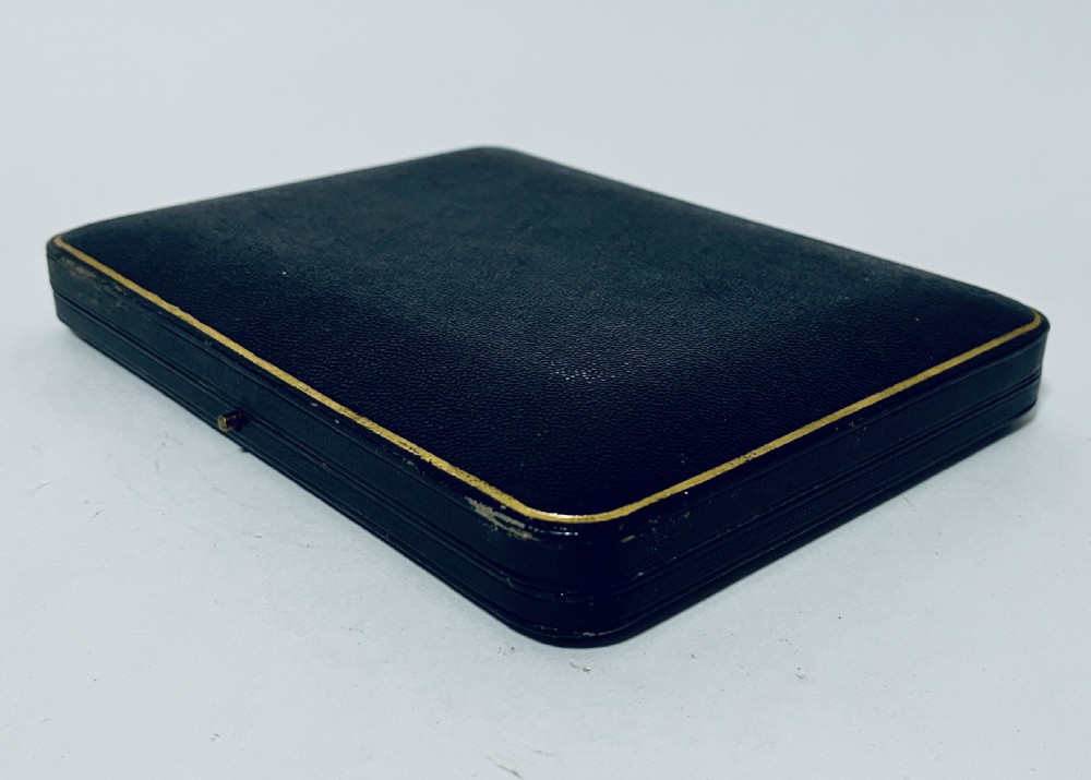 A cased set of six silver teaspoons and matching sugar tongs arranged in a blue velvet lined presentation box with cream satin lid. View VIII