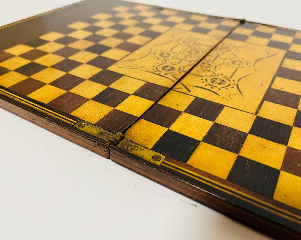 A two-panel antique mahogany solitaire games board featuring indented circular playing tracks alongside a collection of dark glass marbles. View XIV