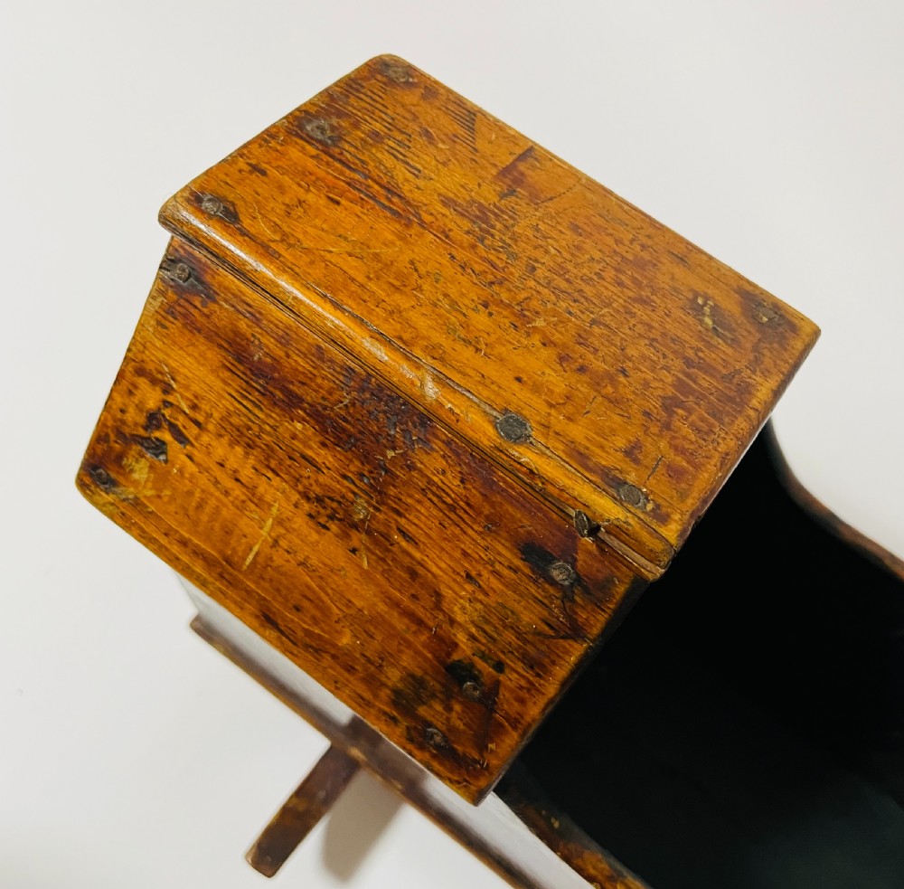A dark stained pine miniature doll cradle featuring a hooded canopy and curved rockers. View III