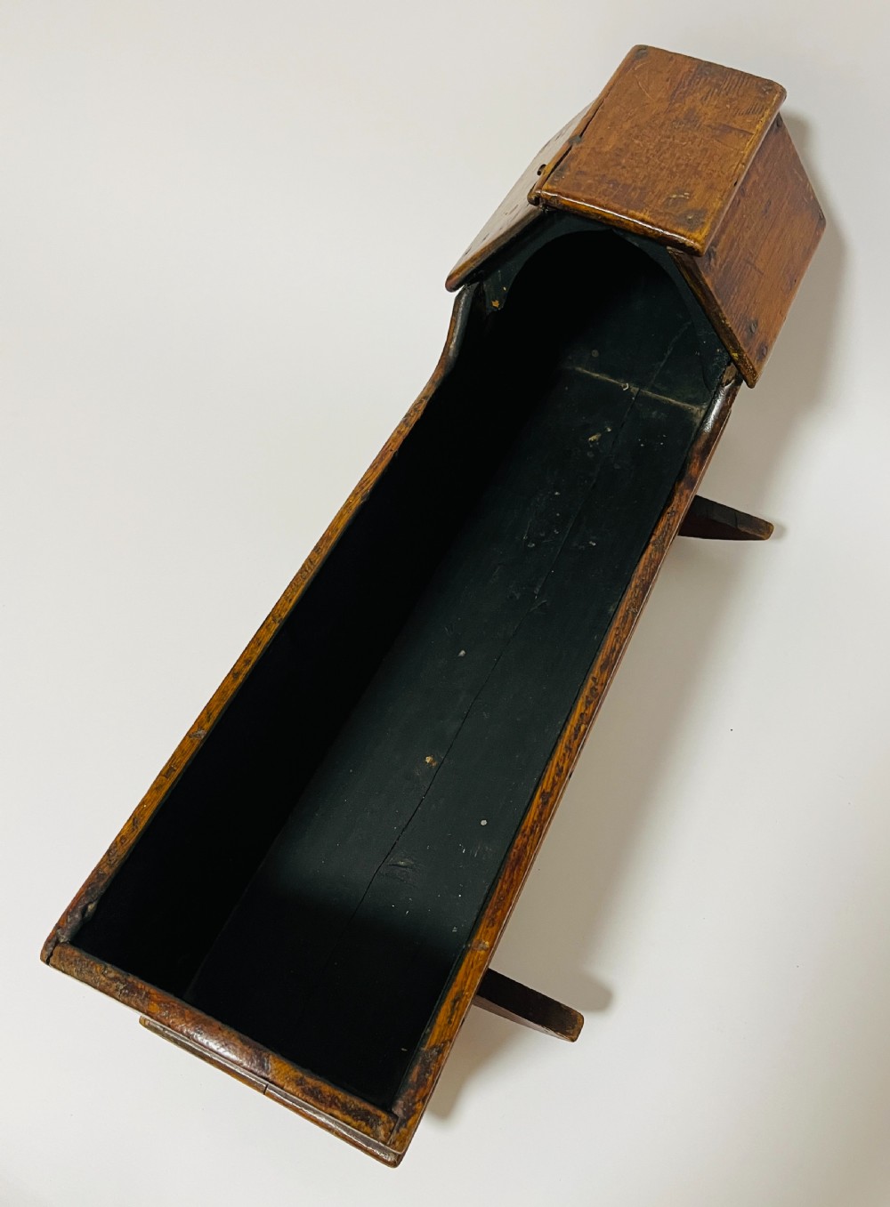 A dark stained pine miniature doll cradle featuring a hooded canopy and curved rockers. View VII