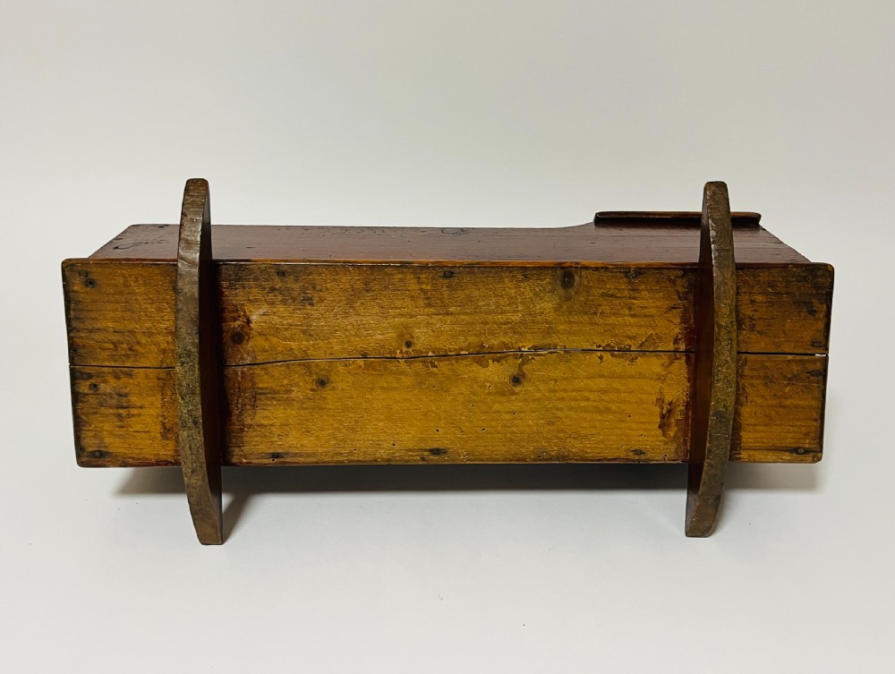 A dark stained pine miniature doll cradle featuring a hooded canopy and curved rockers. View VIII