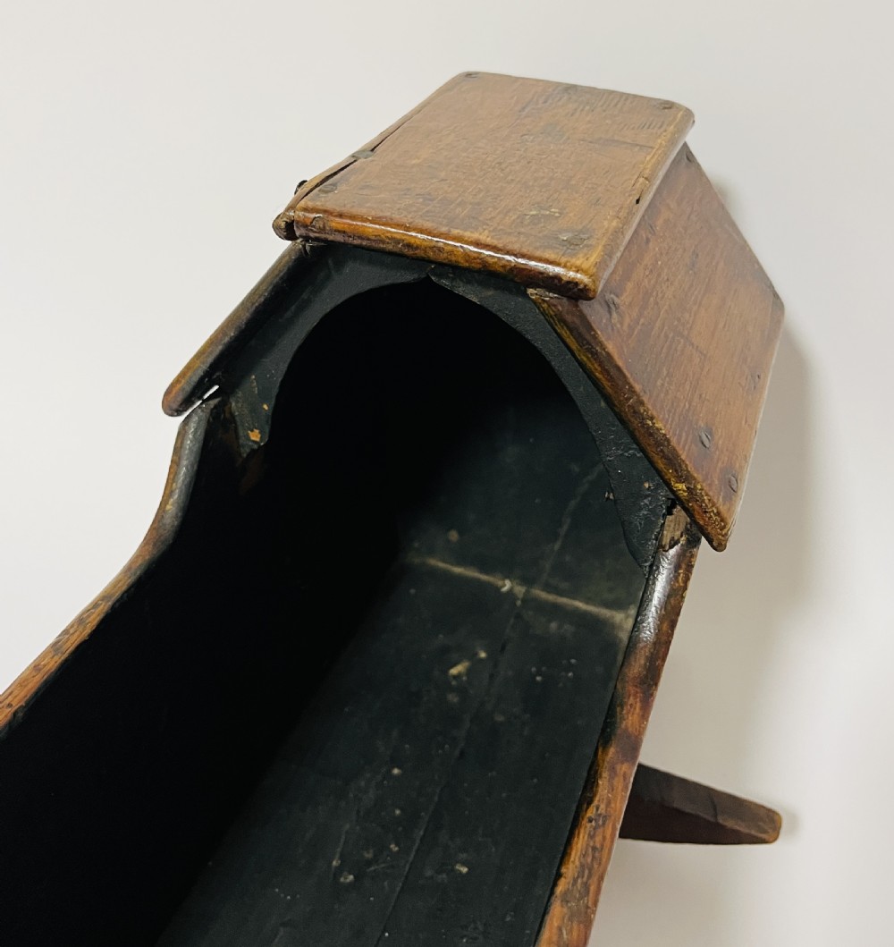 A dark stained pine miniature doll cradle featuring a hooded canopy and curved rockers. View XII