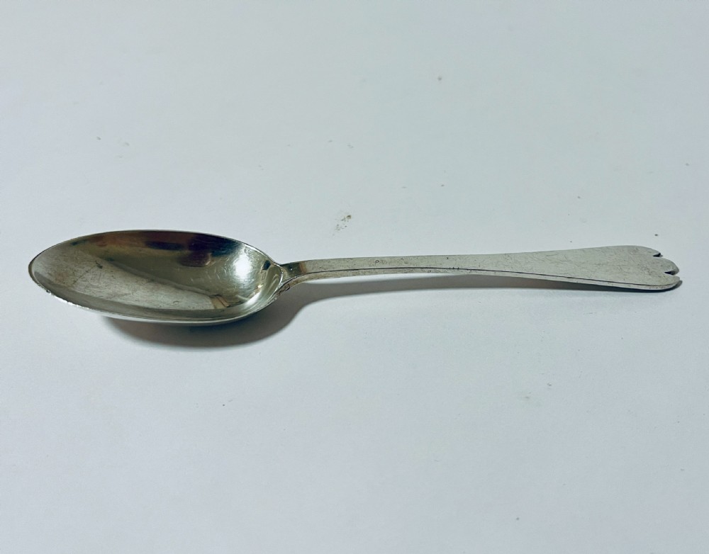 An antique silver trefid spoon featuring a shallow oval bowl and a flat stem terminating in a distinctive notched three-pointed shape. View II