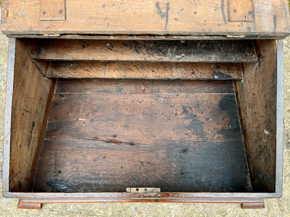 A 17th-century dark oak slant-top desk box featuring iron butterfly hinges and a central brass keyhole escutcheon. View VII