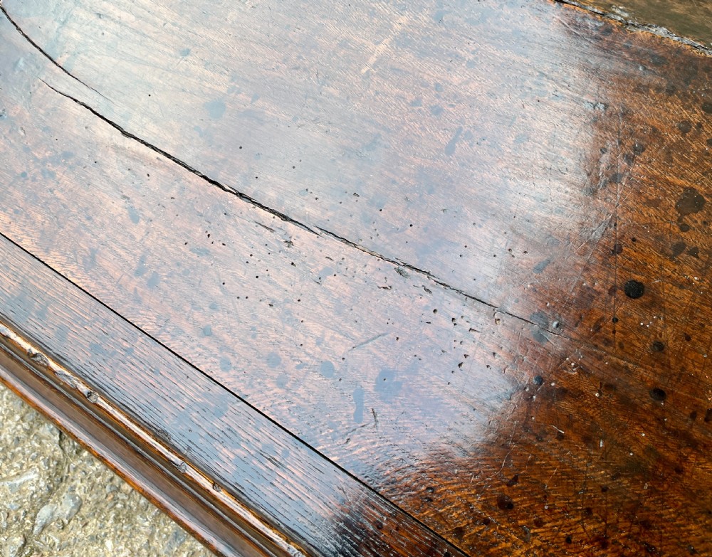 A 17th-century dark oak slant-top desk box featuring iron butterfly hinges and a central brass keyhole escutcheon. View XIII